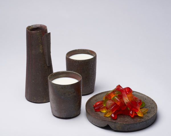 Oesterritter, as much a cook as a ceramicist, makes vessels for use in the kitchen. Each piece is fired in a wood fueled kiln and gets its unique coloring from the way the heat behaves. As someone once said, "You never know what you're gonna get." \n\nHer pieces look like they might be made of iron, like they might have been unearthed at an ancient dig site even. Yet, they are perfectly suited for work in the contemporary kitchen.